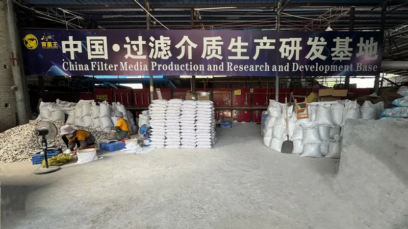 UJW workshop with stacked raw material bags and production base sign
