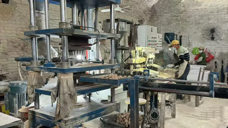Worker operating a ceramic media forming line in the workshop